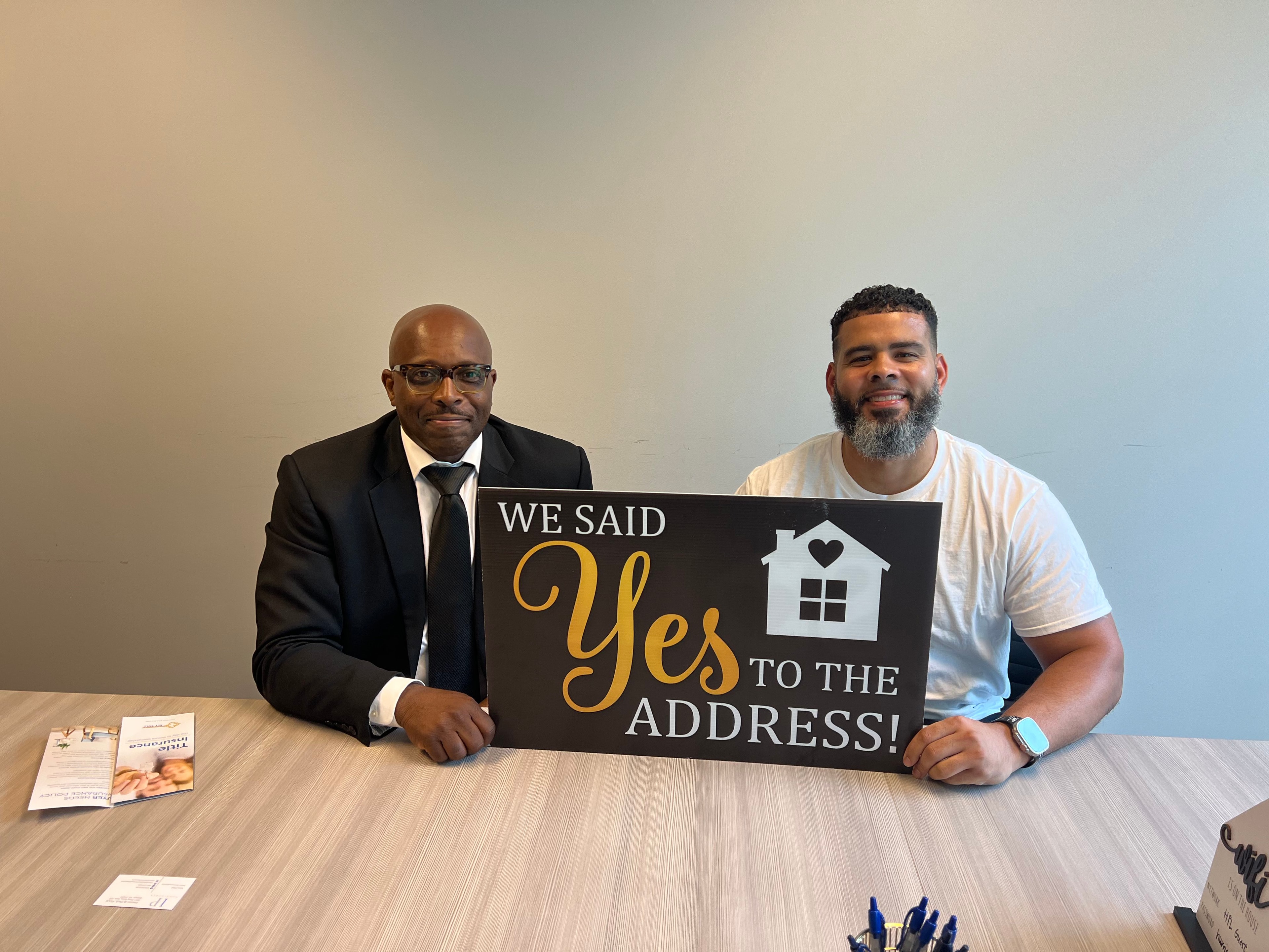 Melda Dunn and team at closing holding We Said Yes to the Address sign